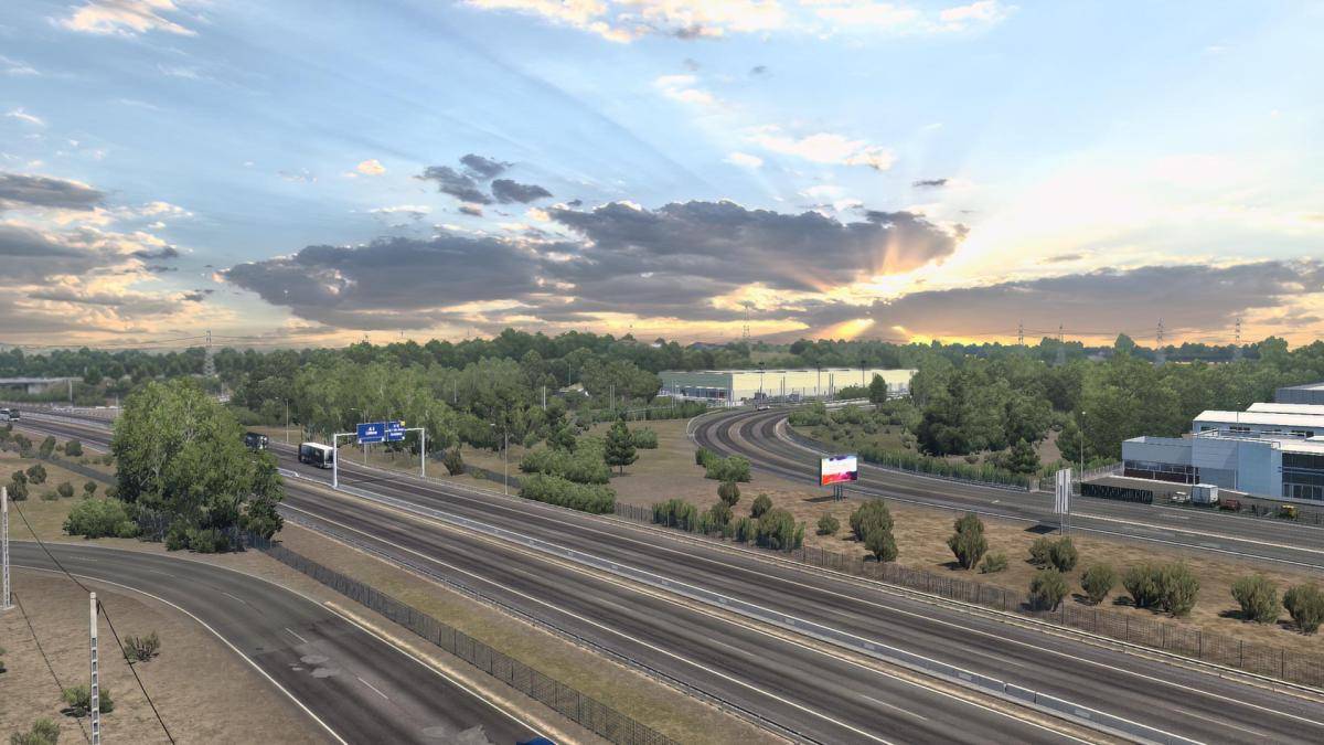 Sun breaking through clouds above a highway